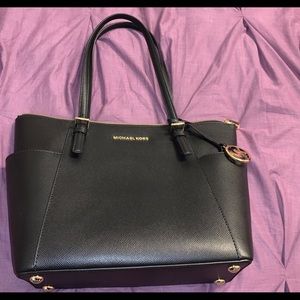 Black Michael Kors bag with 2 side pockets